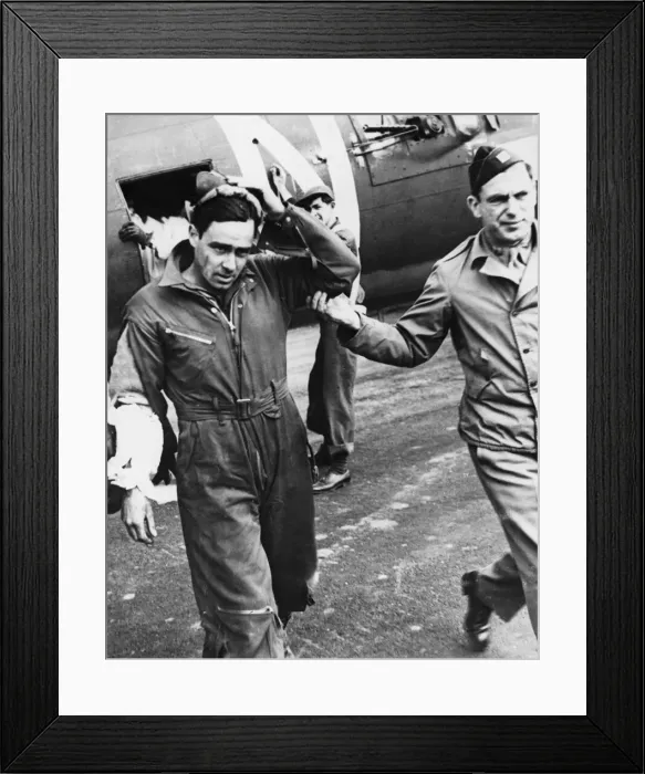 Framed Print : A slightly wounded and shaken waist gunner is led from his place by his flight surgeon Framed Print : A slightly wounded and shaken waist gunner is led from his place by his flight surgeon