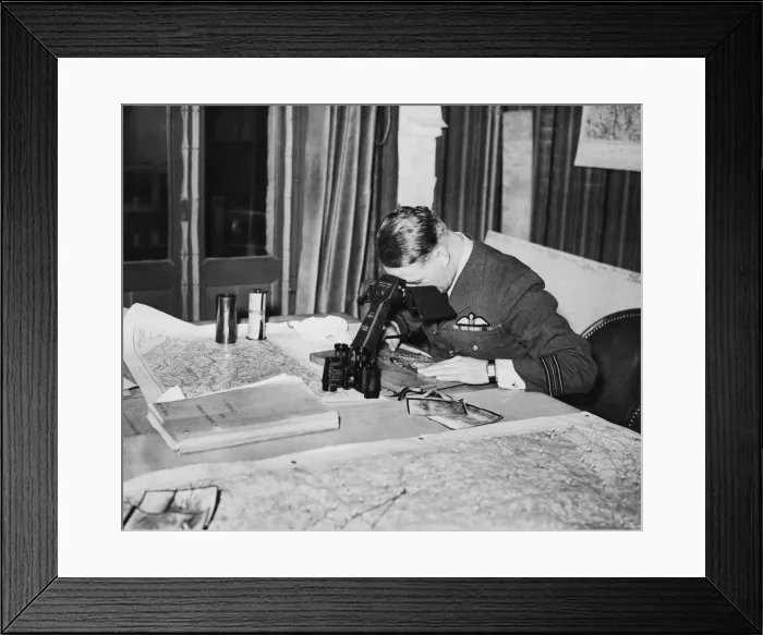 Framed Print : An officer studies reconnaissance pictures taken over Germany at a Wing Headquarters of