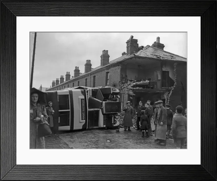 Framed Print : A bus on its side after being caught in the blast of a bomb in Sparkbrook Framed Print : A bus on its side after being caught in the blast of a bomb in Sparkbrook