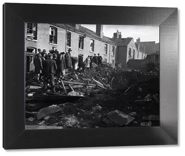 Residents of Vincent Street Balsall Heath, Birmingham, examine a bomb crater following an