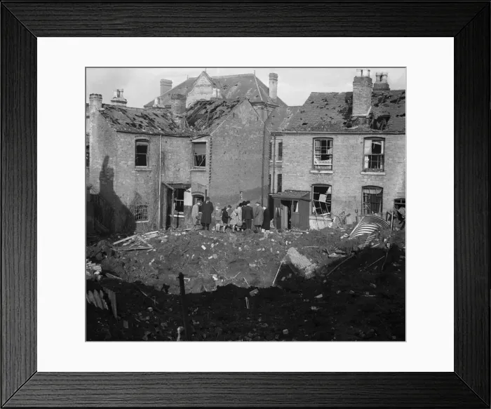 Framed Print : Residents of Vincent Street Balsall Heath, Birmingham, examine a bomb crater following an Framed Print : Residents of Vincent Street Balsall Heath, Birmingham, examine a bomb crater following an