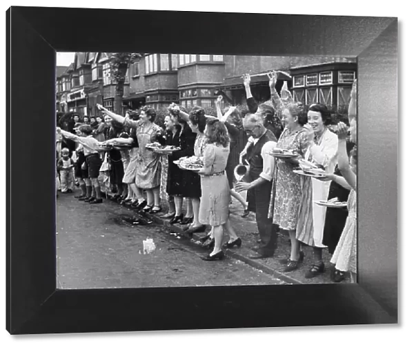 A street in East Ham, June 1944. Neighbours get together to make food