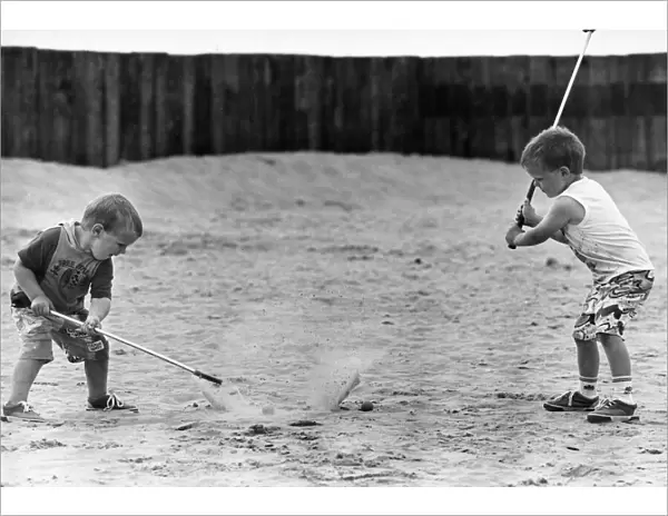 Children practise their golf swing on Ainsdale Beach, Southport