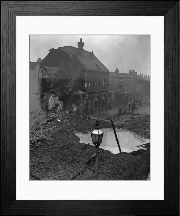 Framed Print : Residents gather around a water filled crater outside a public house in Newtown Row Framed Print : Residents gather around a water filled crater outside a public house in Newtown Row