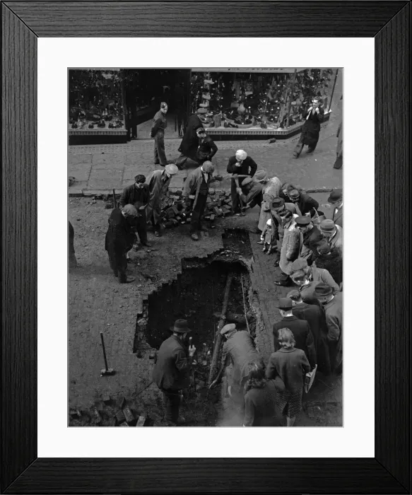 Framed Print : Birmingham residents inspect a bomb crater in Corporation Street, Birmingham