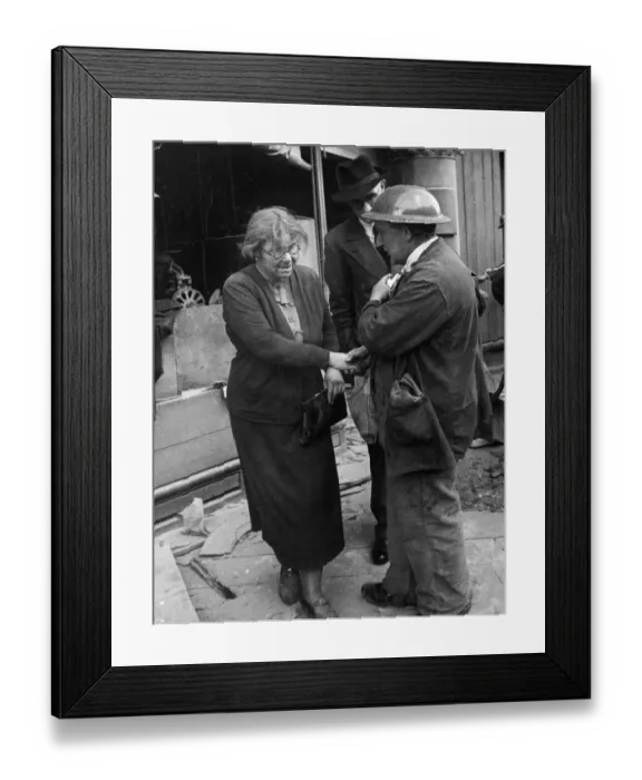 Framed Print : Warden W Russel congratulates a woman woman, covered in dirt and dust