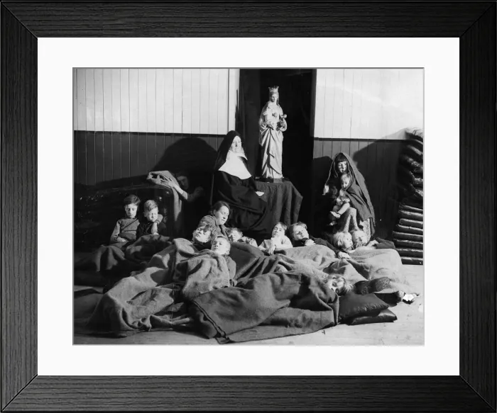Framed Print : A sister of mercy who sits in a chair all night, guarding the homeless at a building near Framed Print : A sister of mercy who sits in a chair all night, guarding the homeless at a building near