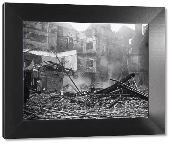 Damage to shops and houses in a West Midlands town following an air raid during