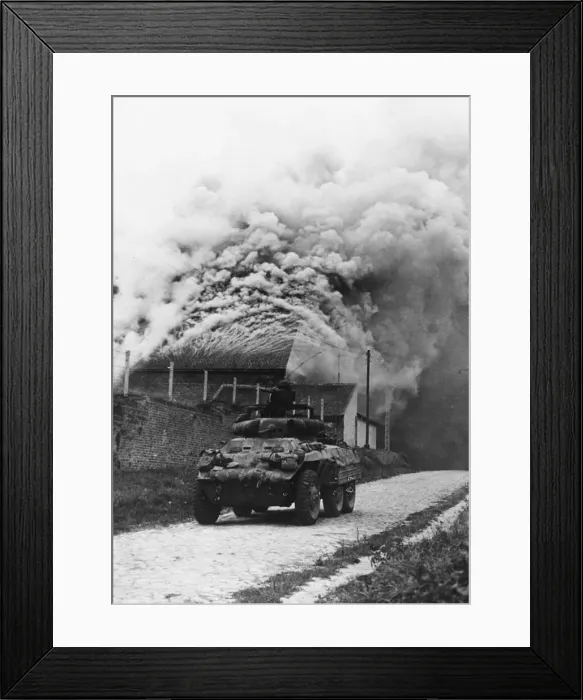 Framed Print : An American armoured car moves through the streets of a town in Belgium Framed Print : An American armoured car moves through the streets of a town in Belgium