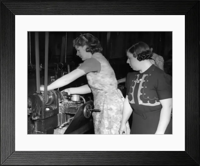 Framed Print : Mrs Knight gets down to some tank parts under the eye of forewoman Mrs Jeanings at a Framed Print : Mrs Knight gets down to some tank parts under the eye of forewoman Mrs Jeanings at a