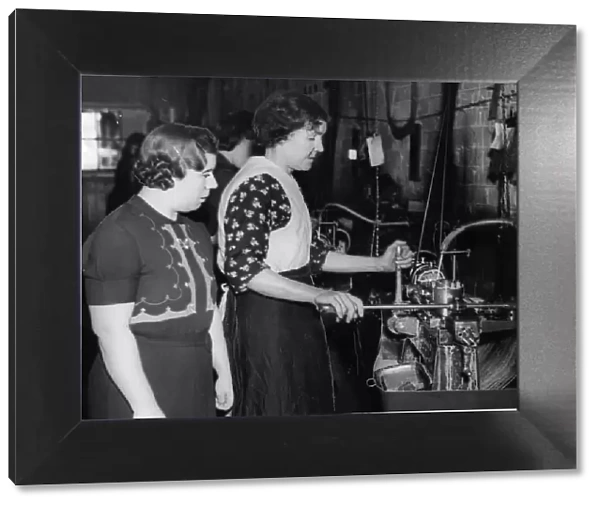 Mrs Jeanings supervising part timer Mrs Williams at her machine in a Birmingham munitions