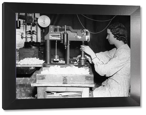 Birmingham factory worker Beatrice Payne, at work making and testing parachute hooks