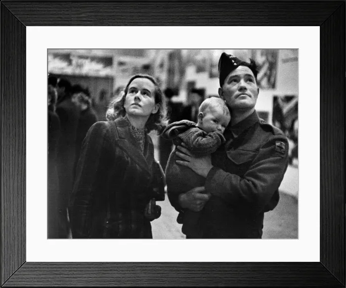 Framed Print : British army gunner Fish and his wife study an exhibit at the Daily Mirror Exhibition of Framed Print : British army gunner Fish and his wife study an exhibit at the Daily Mirror Exhibition of