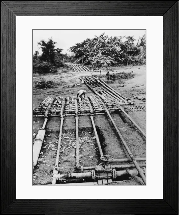 Framed Print : Burmese civilians and US soldiers help construct a manifold valve as part of a pipeline Framed Print : Burmese civilians and US soldiers help construct a manifold valve as part of a pipeline