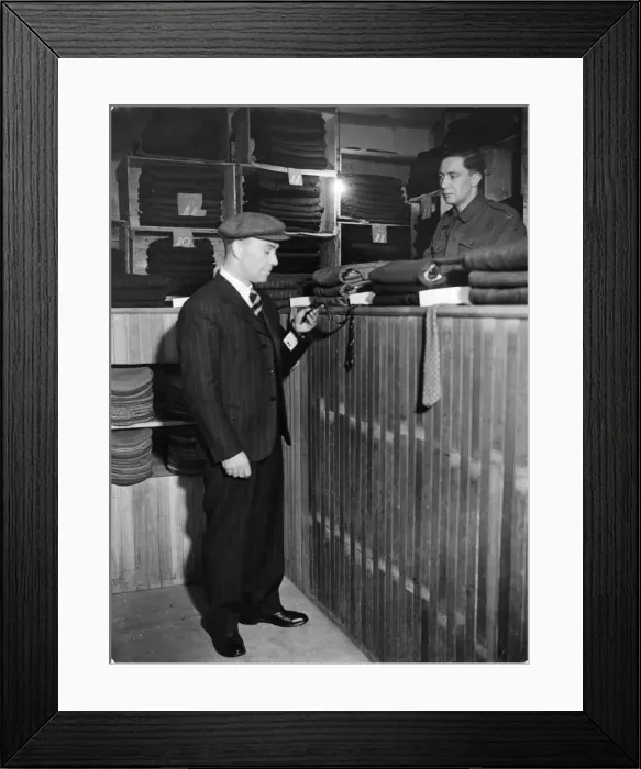 Framed Print : Discharge office in London. Man collecting his new suit