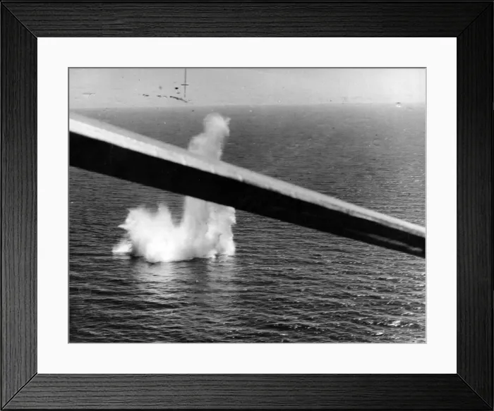 Framed Print : A stick of bombs from a Sunderland aircraft damaging a submarine in the western