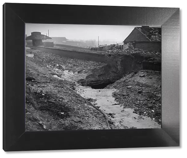 The crater left after a direct hit on the Birmingham to Worcester canal at the Bournville