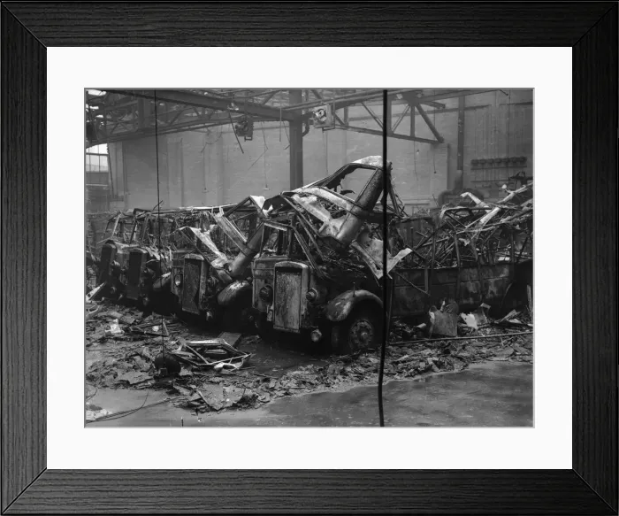 Framed Print : 19 burnt out and four partly burnt out buses sit in the remains of Hockley bus depot