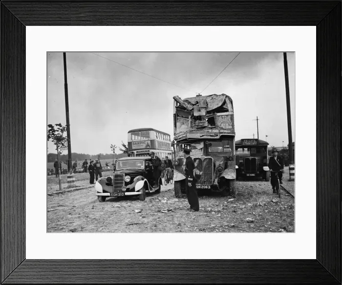 Framed Print : Scene showing considerable damage to the front of a bus following an air raid by Framed Print : Scene showing considerable damage to the front of a bus following an air raid by