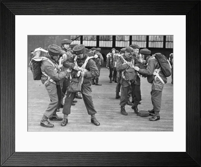 Framed Print : Parachutists practicing with their chutes. Helping each other