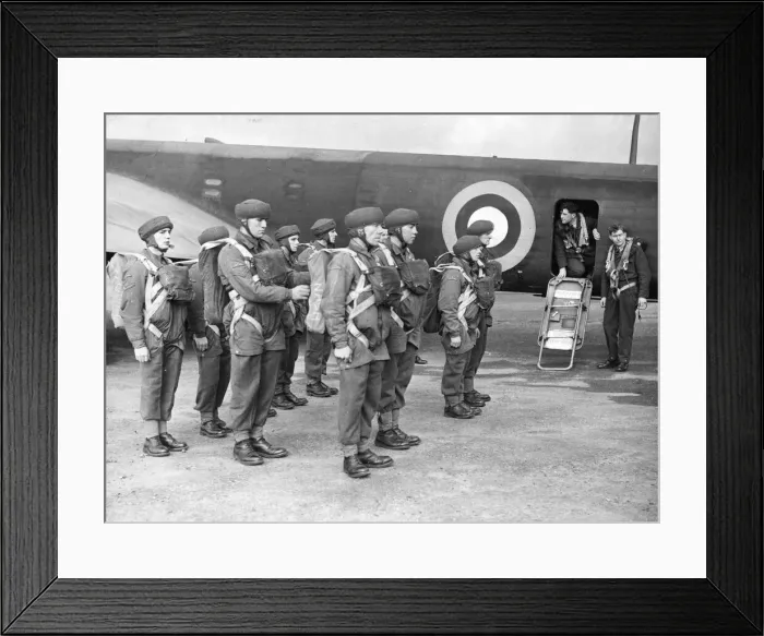 Framed Print : The corporal inspecting the parachute equipment of British parachutists before they enter Framed Print : The corporal inspecting the parachute equipment of British parachutists before they enter