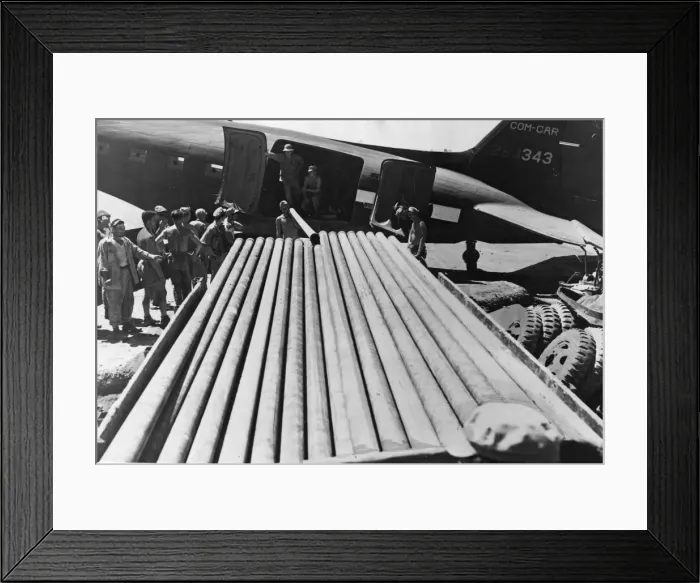 Framed Print : Pipes for use in constructing the long line are transferred by US soldiers from a C-47 Framed Print : Pipes for use in constructing the long line are transferred by US soldiers from a C-47