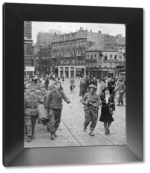 Liberated Antwerp, Belgium. Picture shows a local woman helping a British