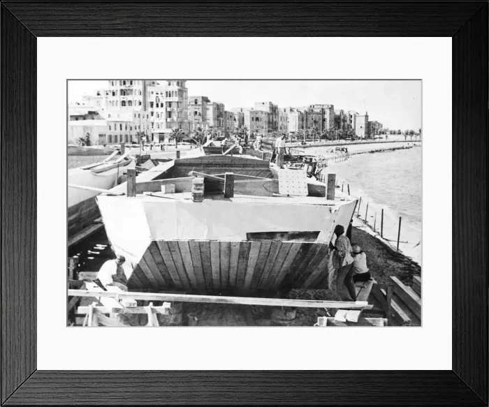 Framed Print : Alexandria, Egypt. Canvas being nailed onto the sides of a flat bottomed barge called a