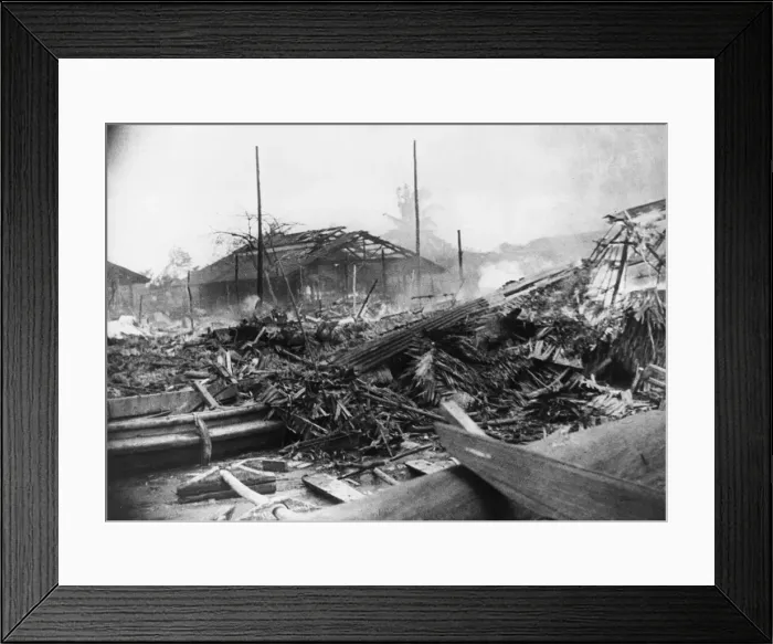 Framed Print : Native houses are reduced to smouldering ruins after the Japanese bombers have passed Framed Print : Native houses are reduced to smouldering ruins after the Japanese bombers have passed