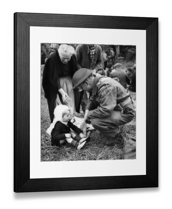 Framed Print : Canadian soldiers tend to French Refugees in Normandy shortly after the successful