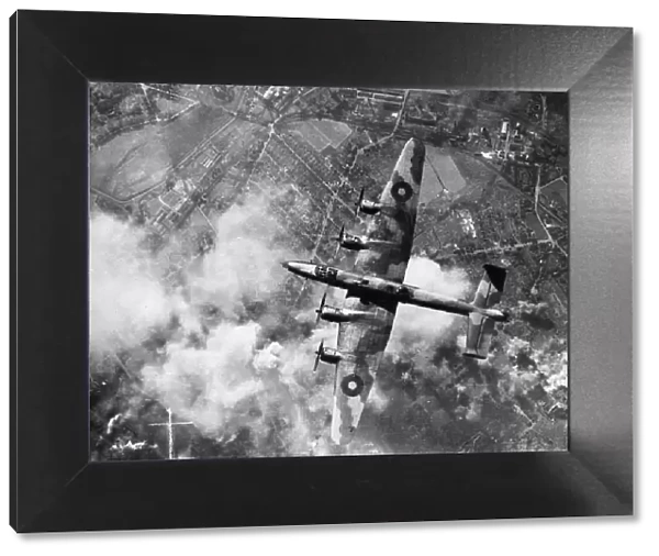 A Halifax bomber of RAF Bomber Command in flight over the target area during a raid