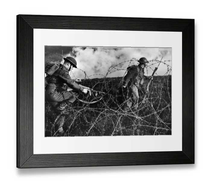 Framed Print : British troops advancing through barbed wire during a training drill. September 1943