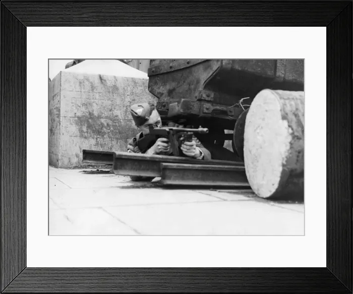 Framed Print : Soldier taking advantage of cover as he fires his gun in a South Wales training exercise