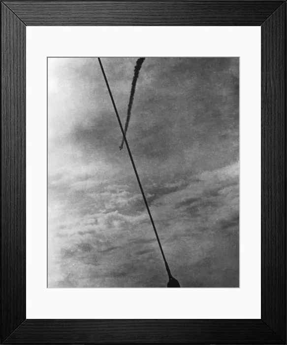 Framed Print : A German bomber shot down by a RAF fighter, caught in a barrage balloon seen here