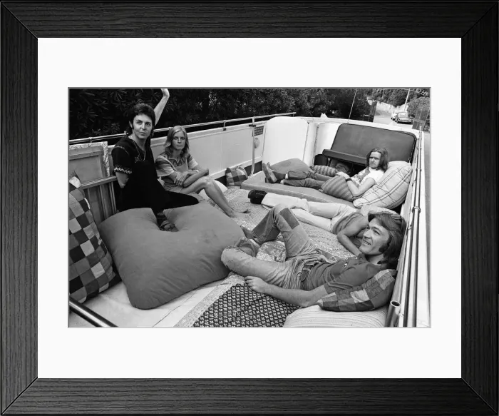 Framed Print : Paul McCartney and his wife Linda in Paris, France, with other members of the group Wings