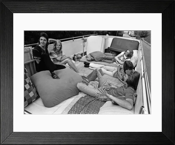 Framed Print : Paul McCartney and his wife Linda in Paris, France, with other members of the group Wings