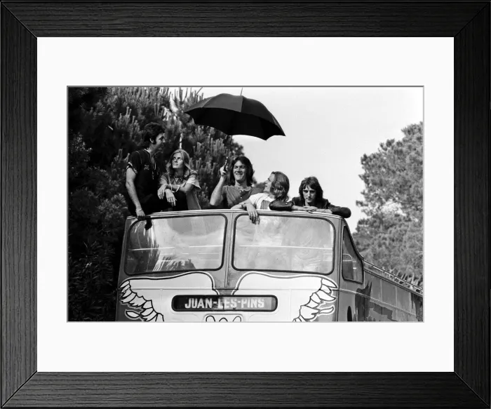 Framed Print : Paul McCartney and his wife Linda in Paris, France, with other members of the group Wings