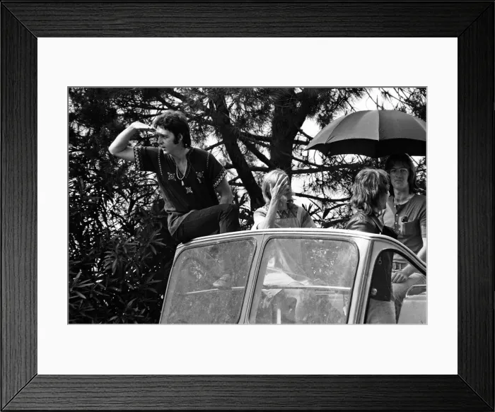 Framed Print : Paul McCartney and his wife Linda in Paris, France, with other members of the group Wings