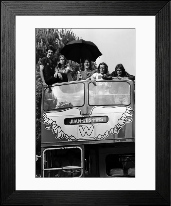 Framed Print : Paul McCartney and his wife Linda in Paris, France, with other members of the group Wings