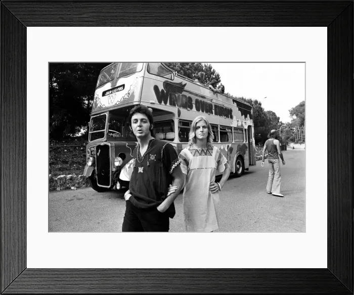 Framed Print : Paul McCartney and his wife Linda in Paris, France, with other members of the group Wings