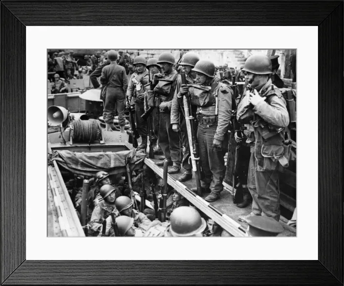 Framed Print : American soldiers laden with equipment and weapons assemble on board a small landing Framed Print : American soldiers laden with equipment and weapons assemble on board a small landing