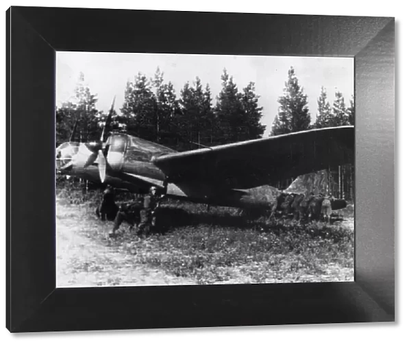 A Soviet bomber concealed in a forest. This picture taken when Russia had