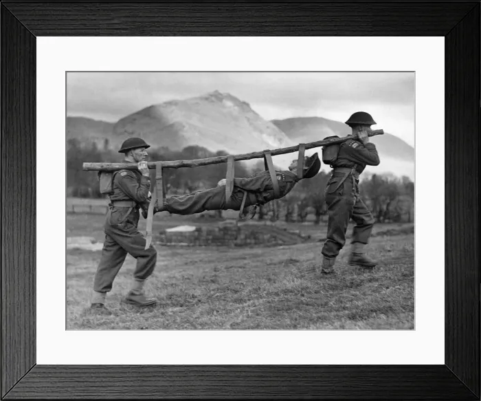 Framed Print : Members of the Royal Army Medical Corps improvise a stretcher for a casualty during a