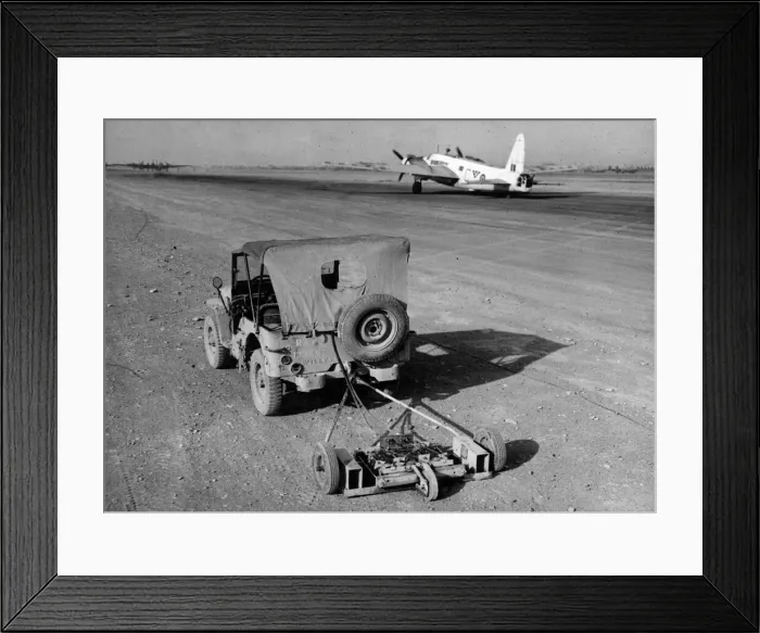 Framed Print : R. A. F. engineers search an airfield for mines using a magnetic sweep attached to a jeep Framed Print : R. A. F. engineers search an airfield for mines using a magnetic sweep attached to a jeep