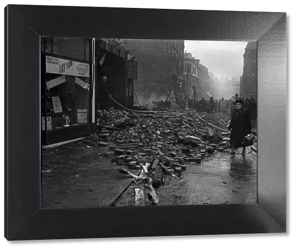 A woman on her way to work negotiates the rubble strewn Smallbrook Street