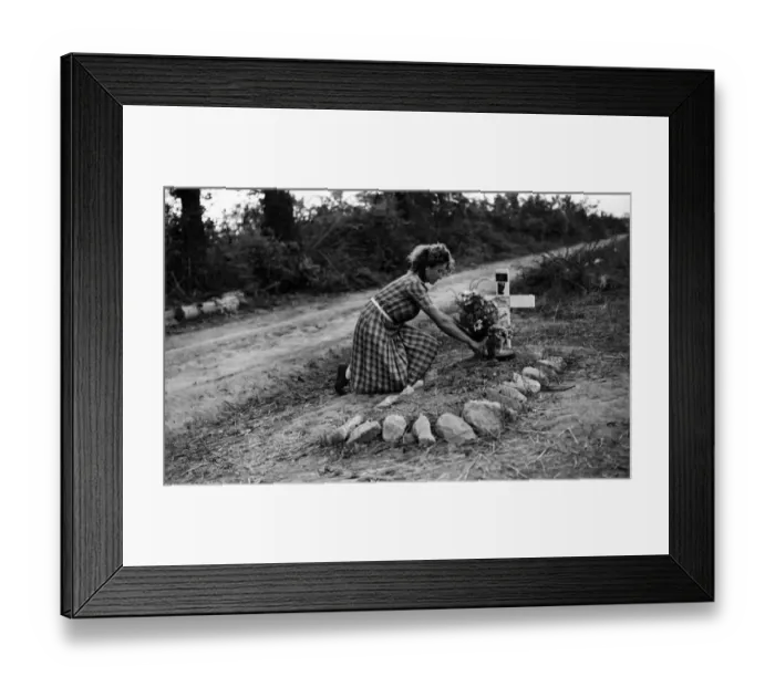 Framed Print : A French girl attends a British soldiers grave in France. August 1944