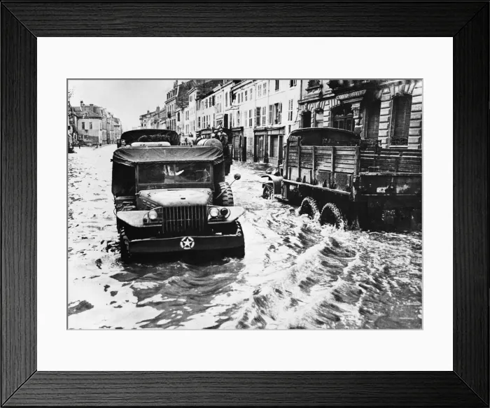 Framed Print : Allied traffic negotiates heavy rain in Rambervillers after a river in this french town Framed Print : Allied traffic negotiates heavy rain in Rambervillers after a river in this french town