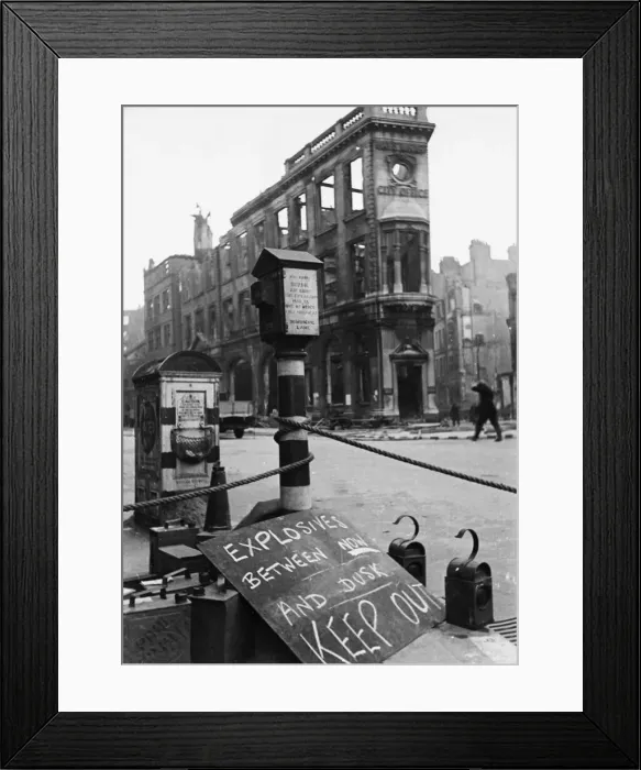 Framed Print : An ominous sign warning of live explosives displaying in a street during the Second World Framed Print : An ominous sign warning of live explosives displaying in a street during the Second World