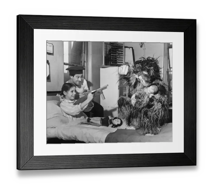 Framed Print : Sheila Welsher, aged 10, from Southfields, near Wimbledon, plays shooting Gerry Lee