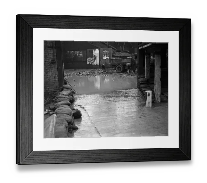 Framed Print : The entrance to the Cadbury factory at Bournville as workmen clean up after flooding Framed Print : The entrance to the Cadbury factory at Bournville as workmen clean up after flooding